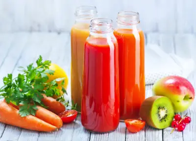vegetables and bottles of juice from Kitchen Juicers
