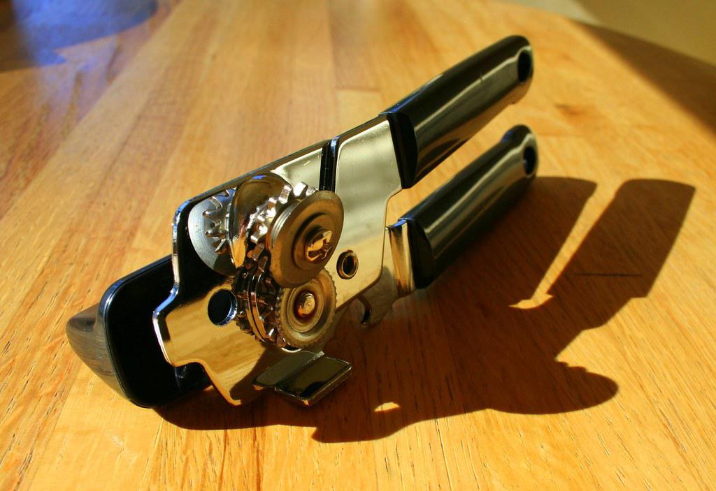 A classic manual can opener with a comfortable padded handle and a durable cutting wheel