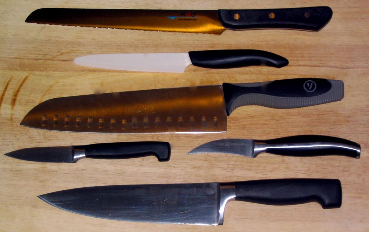 A trio of essential kitchen knives: a serrated bread knife, a paring knife, and a chef's knife